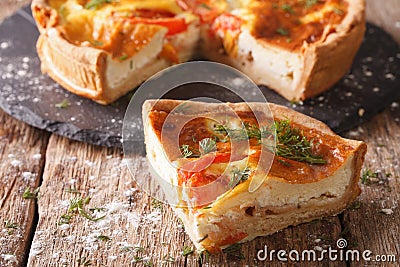 Freshly sliced pie with feta, tomatoes and herbs closeup. horizo