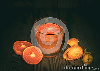 Freshly Squeezed Mandarin Juice in a Glass and Fresh Mandarins on the Wooden Table Stock Photo