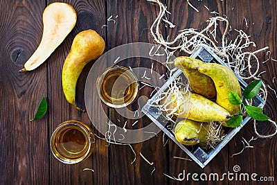 Freshly squeezed pear juice and ripe pear on a wooden table. Top view. The concept of nutrition for superfoods and health or Stock Photo