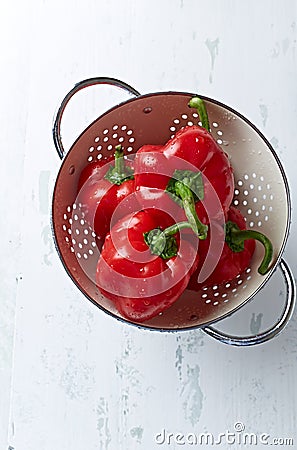 Freshly washed red peppers in a colander Stock Photo