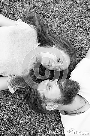 Freshness and peace. Hipster bearded man and girl happy carefree enjoy spring nature top view. Relax on spring grass Stock Photo