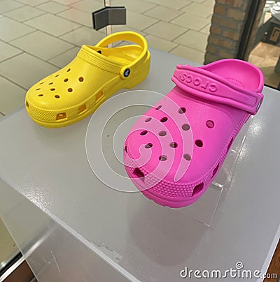 FRESNO, UNITED STATES - Mar 24, 2021: A photo of two Women\'s Croc shoes in bright pink and yellow Editorial Stock Photo