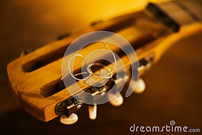 The fretboard of an old vintage guitar with metal strings on a sunny day. A musical instrument. Solfeggio Stock Photo