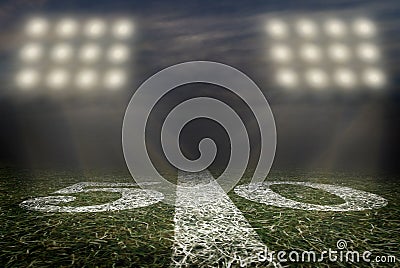 Friday Night Lights Football Game on Football field fifty yard line background Stock Photo