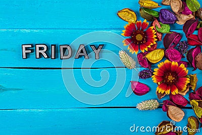 Friday word on blue wood with flower Stock Photo