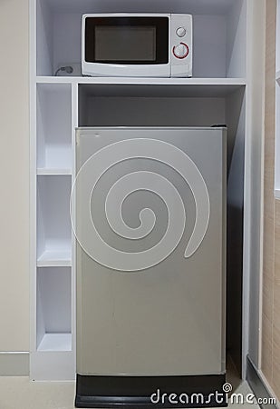 Fridge and a microwave in a built in furniture Stock Photo