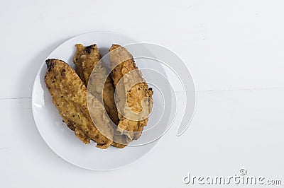 Fried bananas, banana fritters or pisang goreng on white background Stock Photo
