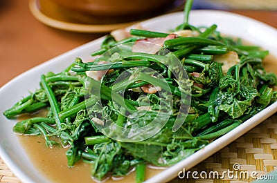 Fried bitter gourd leaf with oyster sauce Stock Photo