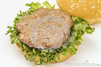 Fried burger bun on lettuce leaf. Top view Stock Photo