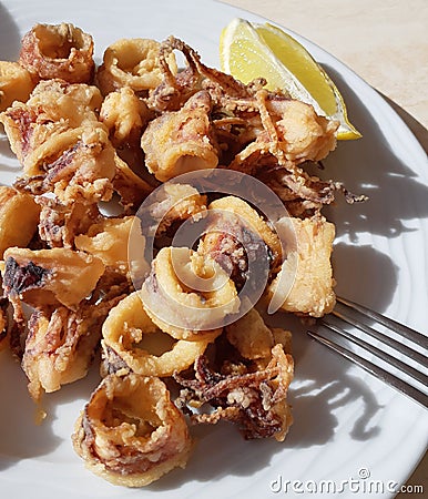 Fried calamary and mini octopus in dish on cook table Stock Photo