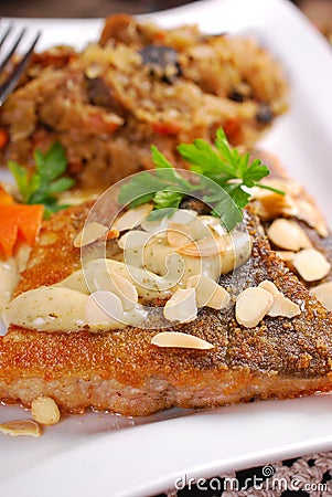 Fried carp with almonds and sauerkraut for christmas eve Stock Photo