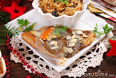 Fried carp with almonds and sauerkraut for christmas eve Stock Photo