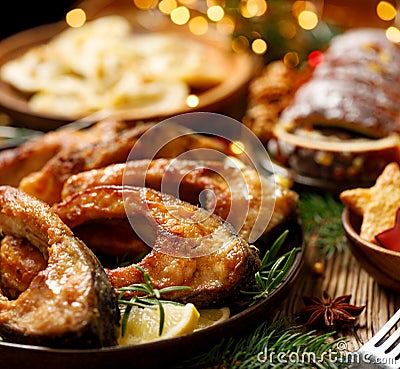 Fried carp fish slices on a ceramic plate, close up. Traditional christmas eve dish. Stock Photo