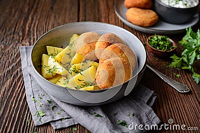 Fried cauliflower and cheese croquettes with boiled potatoes and sour cream dip Stock Photo