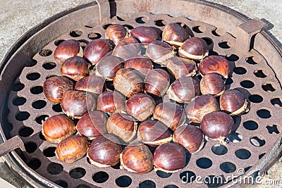 Fried chestnuts on the street. Stock Photo