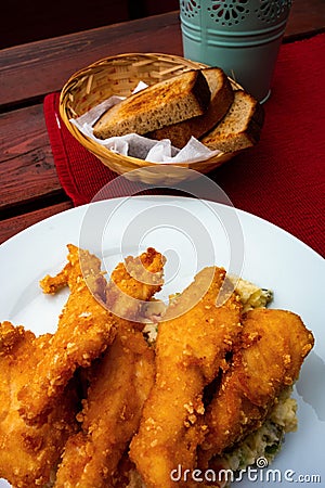 Fried chicken schnitzel, potato salad, bread Stock Photo