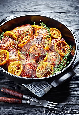 Fried Chicken Thighs With Roasted Lemon Slices Stock Photo