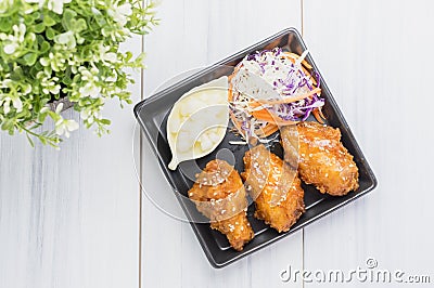 Fried chicken wing and salad on tablecloth on white wood table in kitchen,food menu appetizer Stock Photo