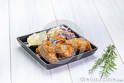 Fried chicken wing and salad on tablecloth on white wood table in kitchen,food menu appetizer Stock Photo