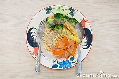 Fried 3 colors vegetable with brown rice on plate Stock Photo