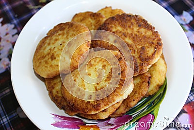 Fried cottage cheese cheesecakes in a plate Stock Photo