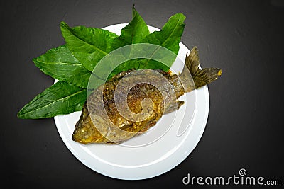 Fried crucians in a pan. Cooking fried fish. A dish of fried crucian carp. Tasty river fish Stock Photo