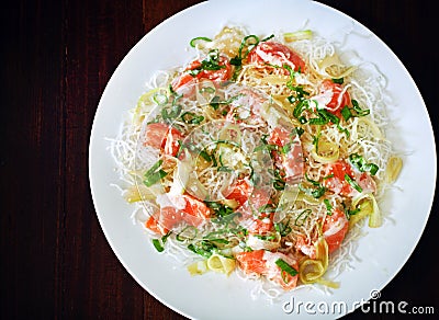 Fried crunchy rice noodles with salmon ceviche, scallions and sesame seeds Stock Photo