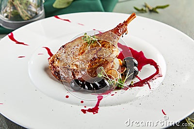 Fried duck leg with mini-pancakes Stock Photo