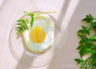 Fried egg with Green on glass plate. Creative idea. Breakfast time. Healthy lifestyle. Stock Photo