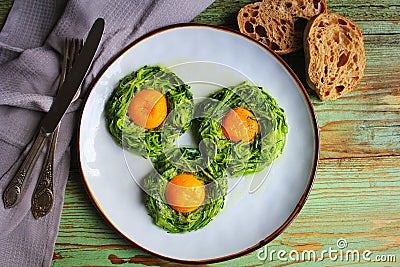 Fried egg in zucchini noodle nest, healthy breakfast, top view Stock Photo