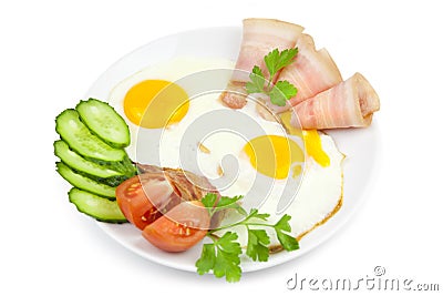 Fried eggs with bacon and vegetables Stock Photo