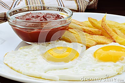 Fried eggs with french fries Stock Photo