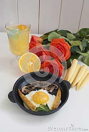 Fried eggs with mini corn and roses Stock Photo
