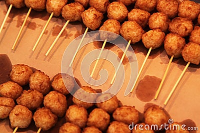 Fried fish balls on skewers for sale Stock Photo