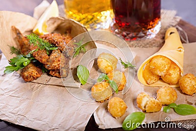 Fried fried fish and cheese balls with lemon and greens. Stock Photo