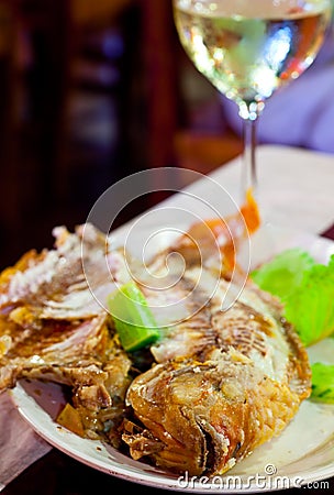 Fried fish on grill in salt Stock Photo