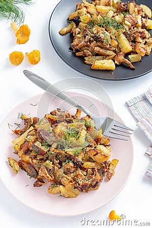 Fried forest chanterelle mushrooms with potatoes Cantharellus cibarius Stock Photo