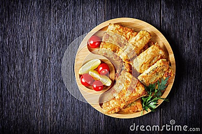 Fried hake fillet on an eco-friendly bamboo plate Stock Photo