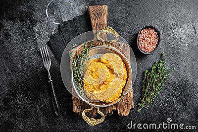 Fried Hash brown potato, hashbrown in a skillet. Black background. Top view Stock Photo
