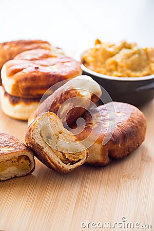 Fried Lenten pies filled with cooked peas inside, on a wooden table. Stock Photo