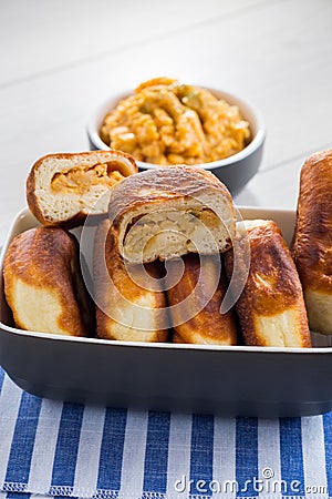 Fried Lenten pies filled with cooked peas inside, on a wooden table. Stock Photo