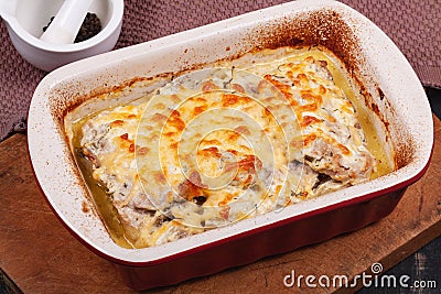 Fried meat in the oven under melted cheese Stock Photo