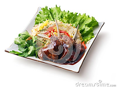 Fried meat ribs in sauce with rice salad... Stock Photo