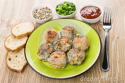 Fried meatballs in green plate, ketchup, green onion, bread Stock Photo