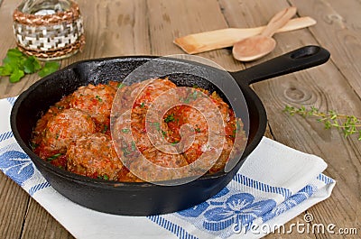 Fried meatballs with tomato sauce and spices in frying pan Stock Photo