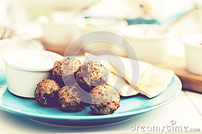 Fried minced meat with sauce and tortillas, traditional Greek lunch on a blue plate in a restaurant Stock Photo