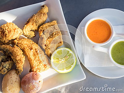 Fried moray eel with salt potato, accompanied by mojo picon and green mojo. Typical dish of the cuisine of the Canary Islands Stock Photo