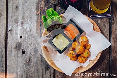 Fried Mozzarella Cheese Balls served with mayonnaise and thousand island sauce in wooden bowl Stock Photo