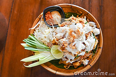 Fried noodle shrimp prawn and crab meat, Thai food noodles stir fry vegetables and rice vermicelli with egg cooked Asian food Stock Photo