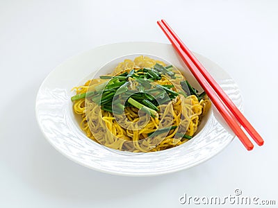 Fried noodles with red chopstick in white plate on white backgro Stock Photo
